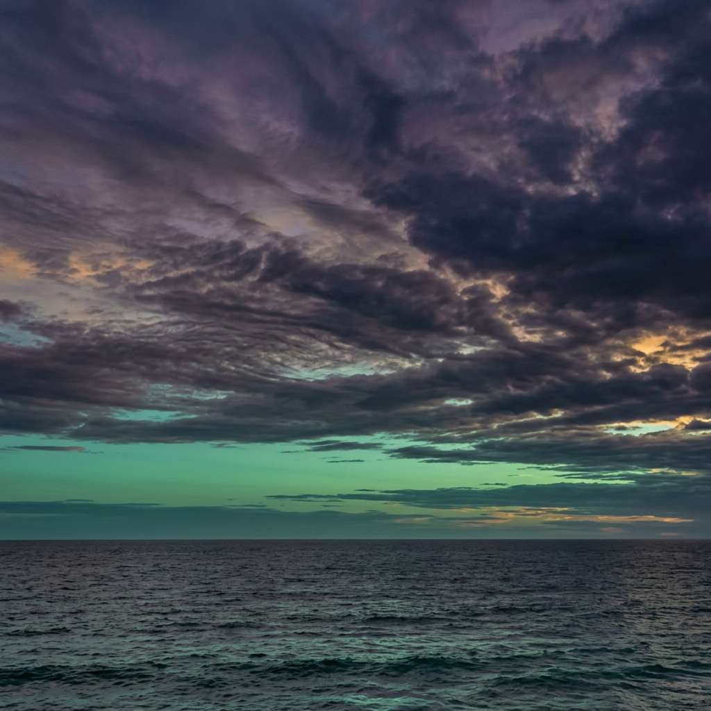 Ocean horizon with dark, dramatic clouds and subtle sunset colors